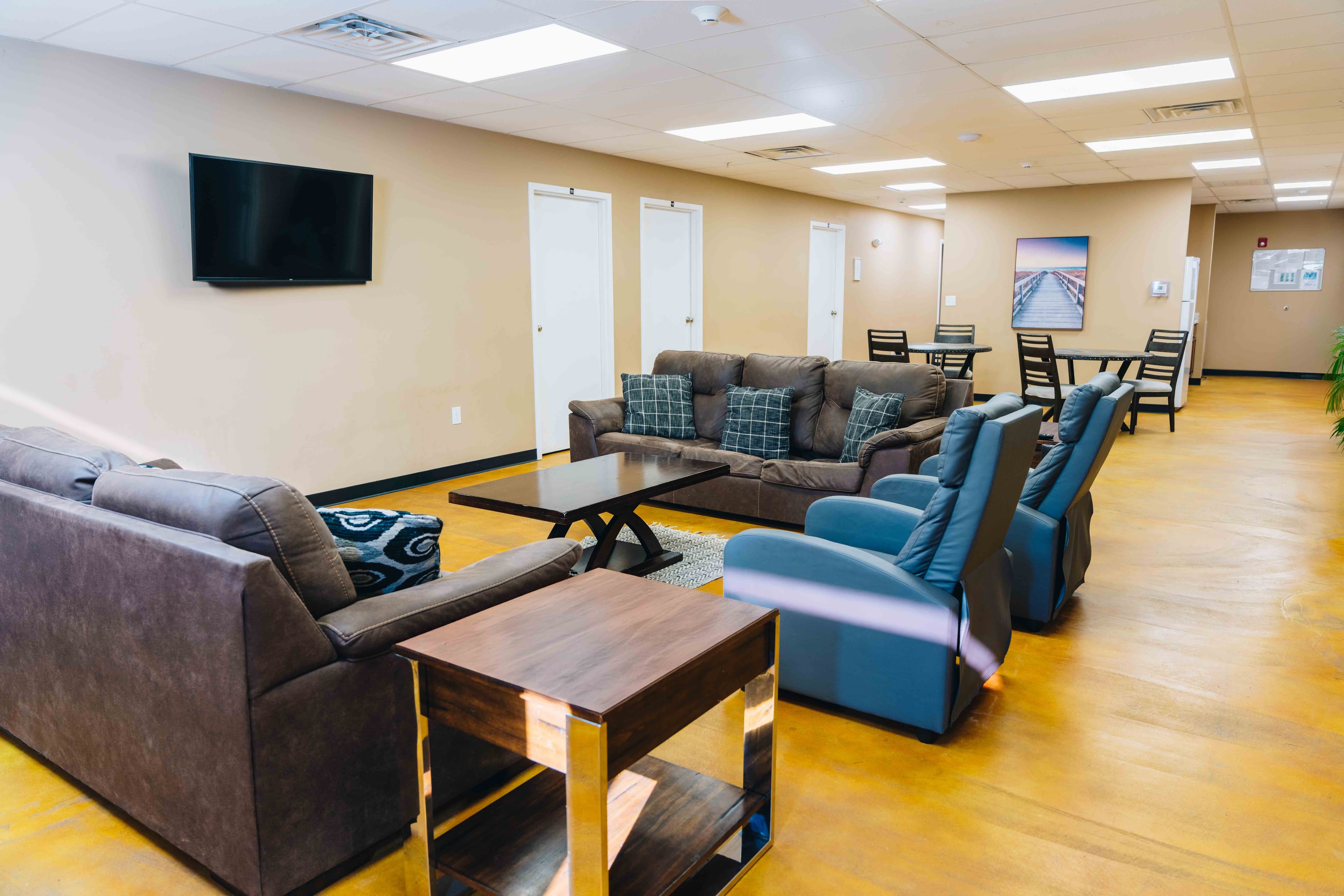 Men's lounge area with comfortable sectional couch and TV