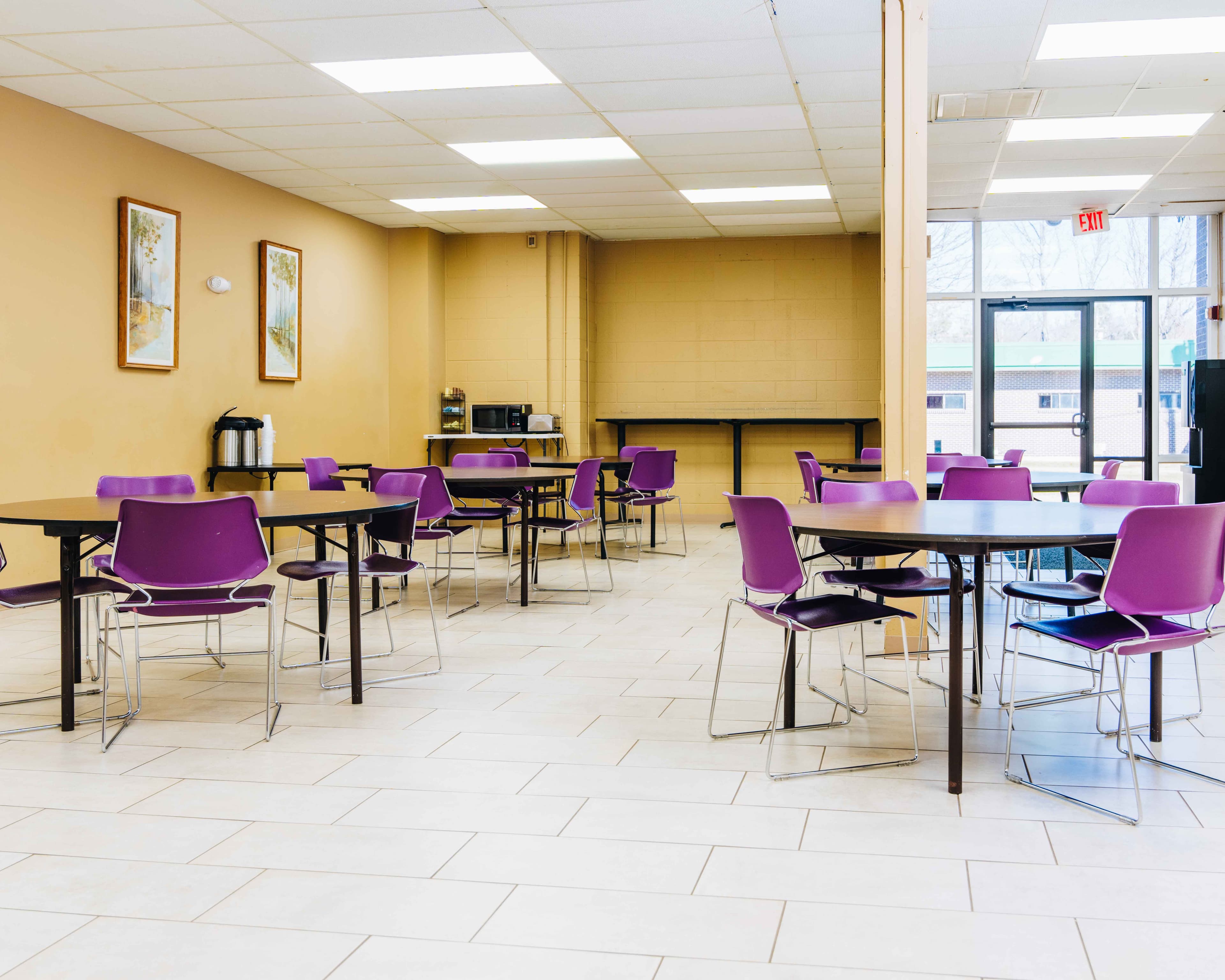 Cafeteria dining room with purple chairs