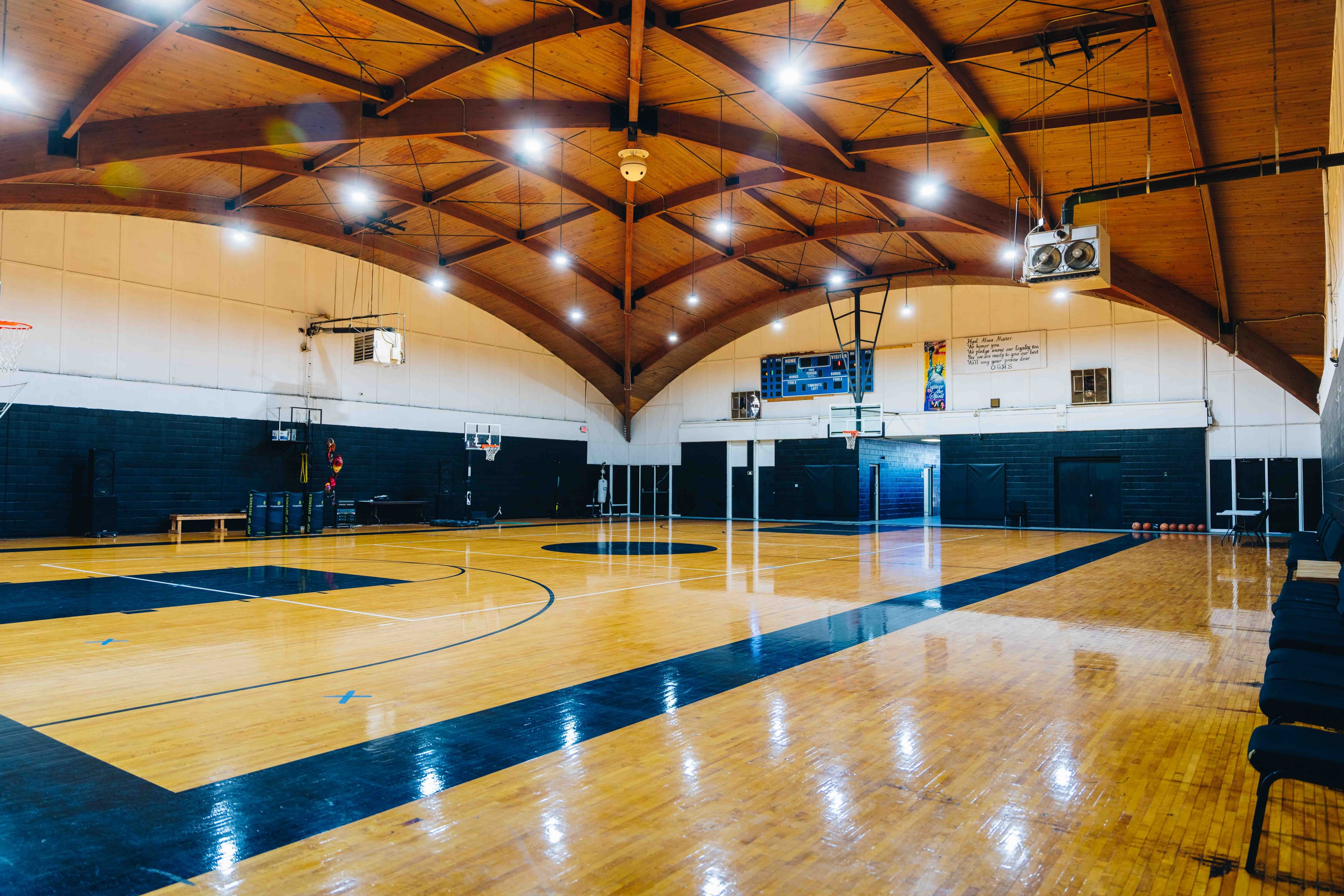 Open gymnasium with vaulted wood ceiling