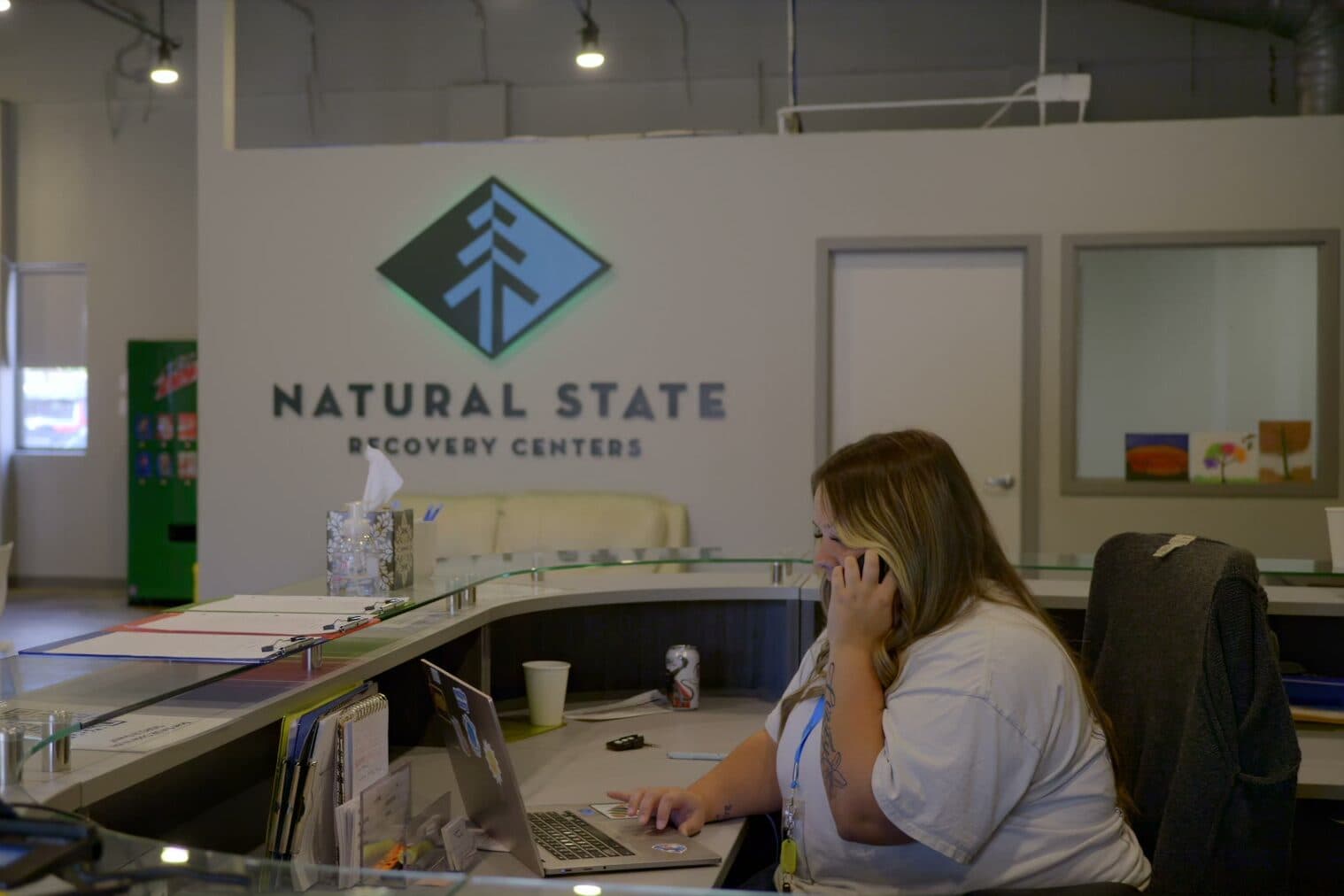 Receptionist on the phone at the Natural State Recovery Centers front desk