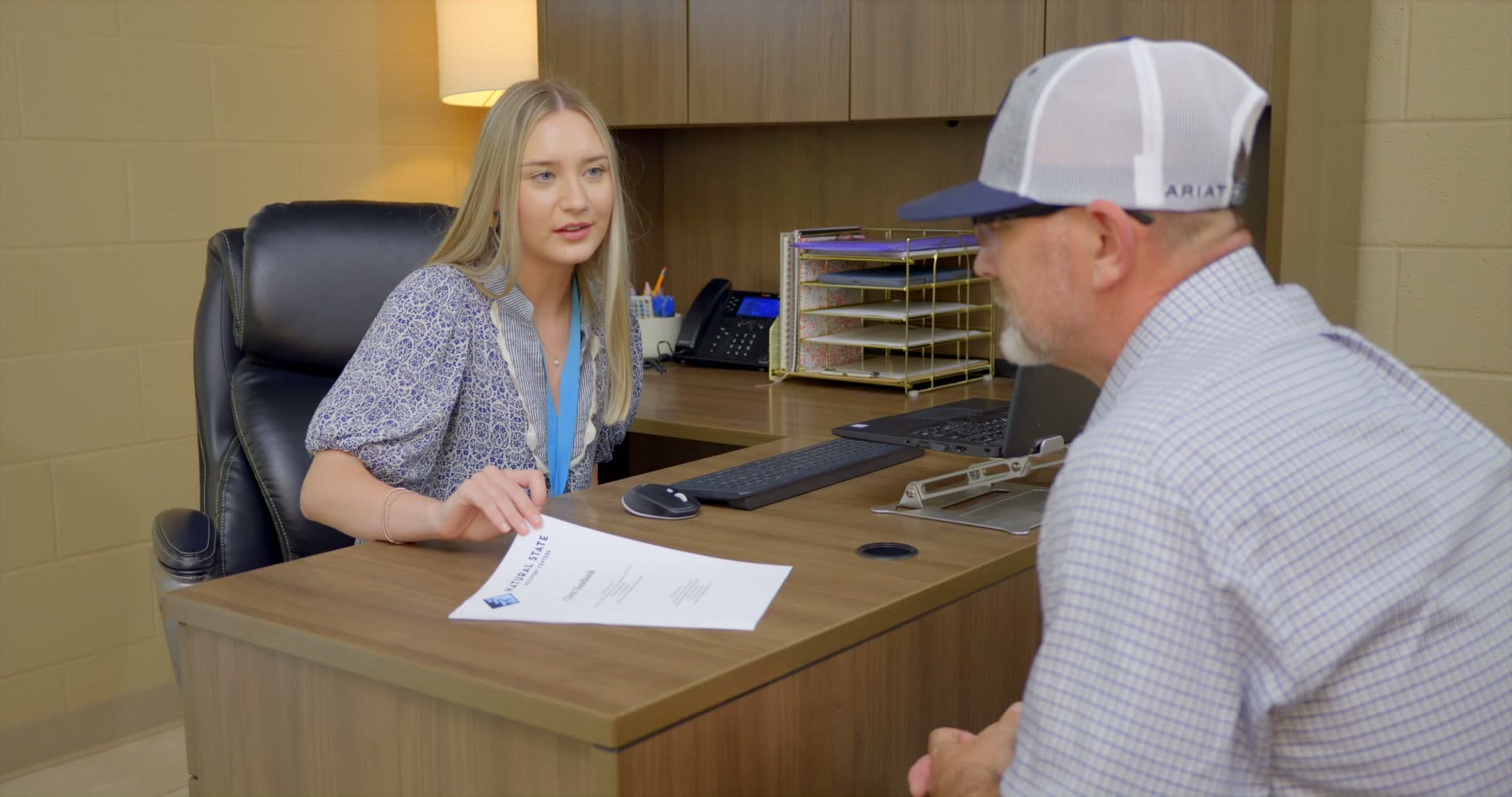 Admissions staff member talking with a client across a desk at Natural State Recovery Centers