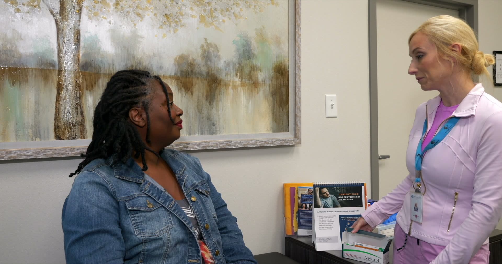 Nurse talking with a client in a treatment office