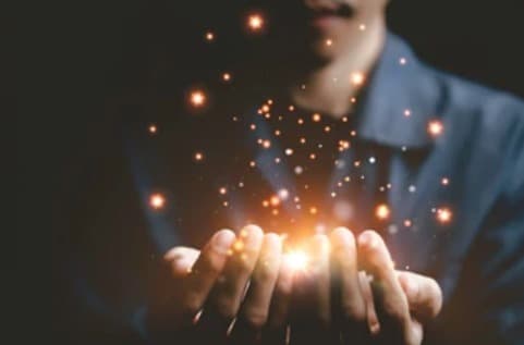Hands holding glowing light symbolizes hope